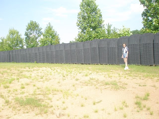 Sherrie Wilcox Standing Next to FEMA Coffins