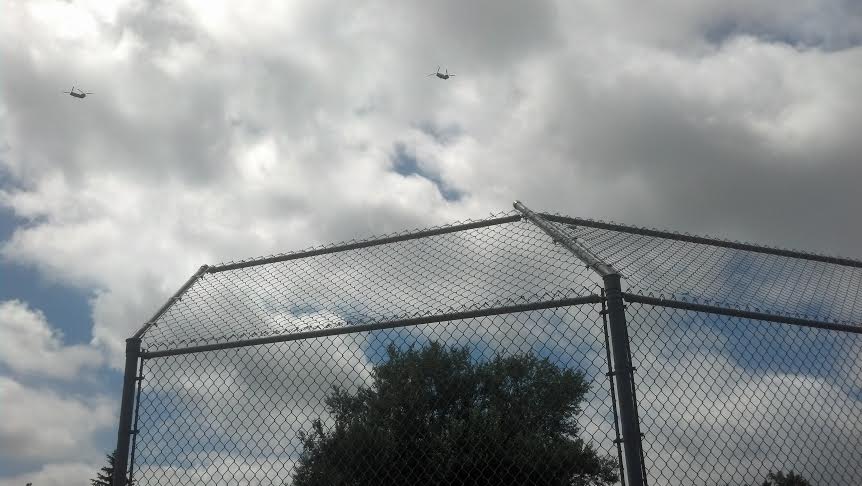 Chinook helicopters over  little league baseball game in Sioux Falls, South Dakota. 